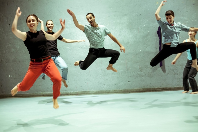 Image of  fouryoung people jumping in the air as part of a performance