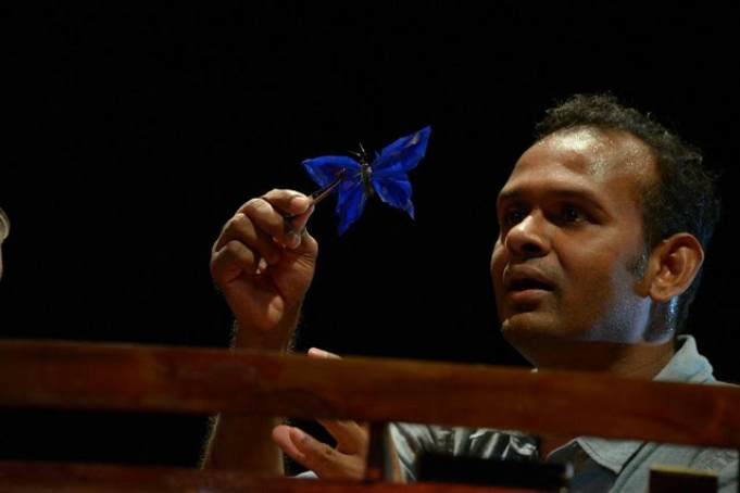 Images of Ramesh Meyyappan in performance holding a butterfly puppet